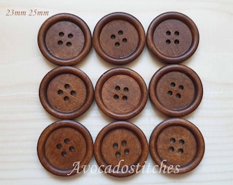 May include: Eight brown wooden buttons with four holes each. The buttons are 23mm and 25mm in diameter.