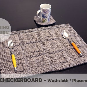 May include: Knitting pattern for a grey washcloth or placemat with a vintage checkerboard design. The pattern is shown with a fork and spoon on top of the finished project.