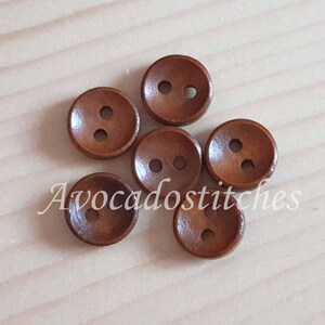 May include: Six brown wooden buttons with two holes each. The buttons are arranged in a circle.