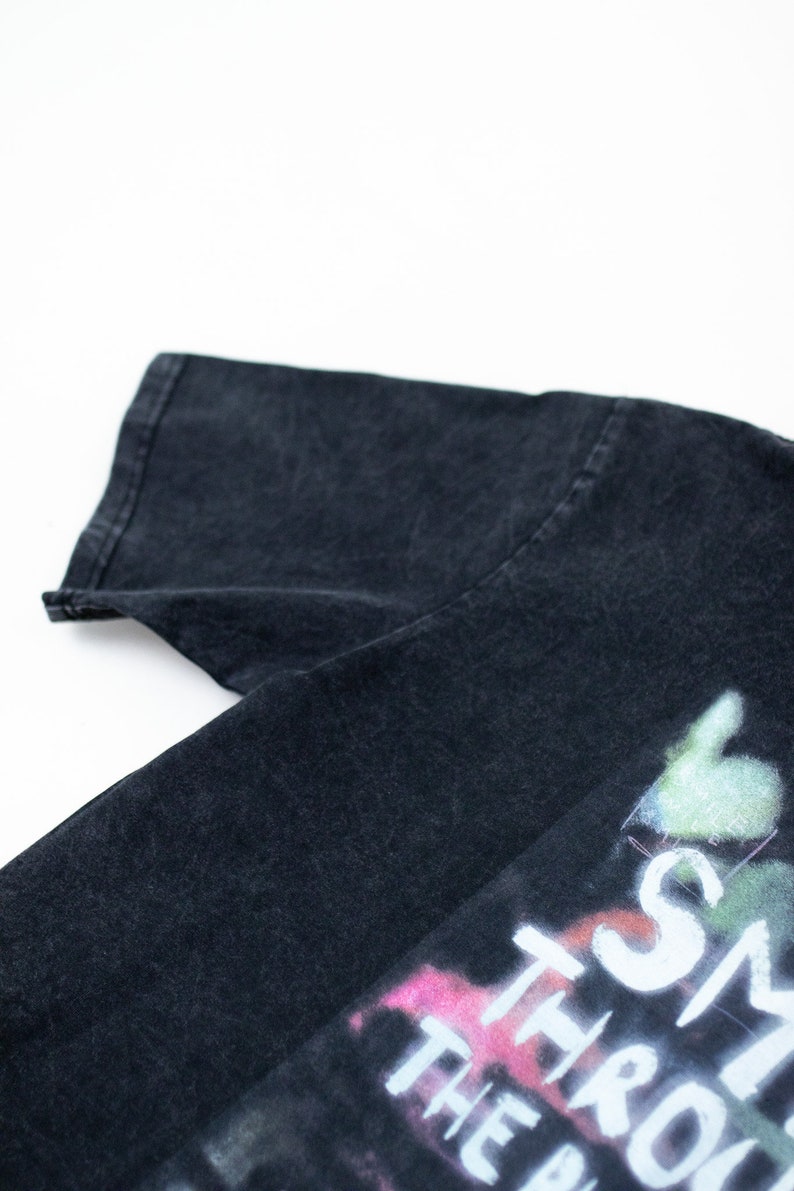 May include: Black t-shirt with a faded graphic print that says "Smile Through The Pain".