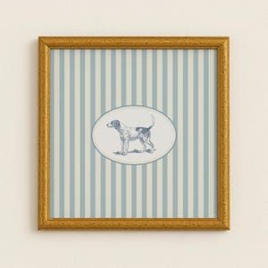 May include: A framed print featuring a dog illustration. The dog is depicted in a detailed sketch within an oval frame. The background has vertical stripes in light blue and off-white, encased in a gold-colored frame.