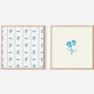 May include: Two framed prints, one with a blue floral pattern and the other with a single blue flower.