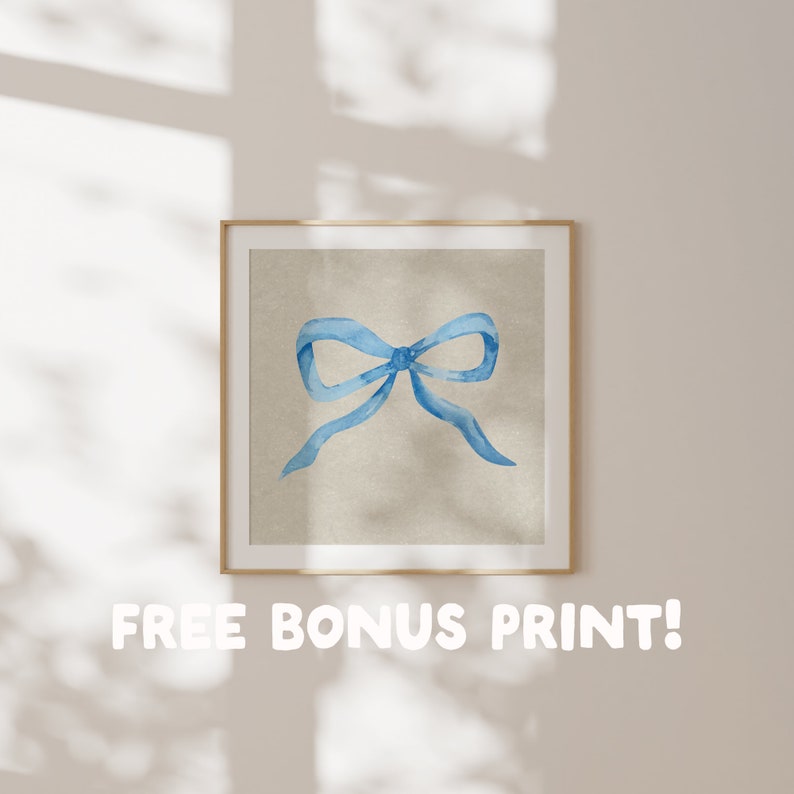 May include: A framed print of a watercolor painting of a blue bow on a beige background.