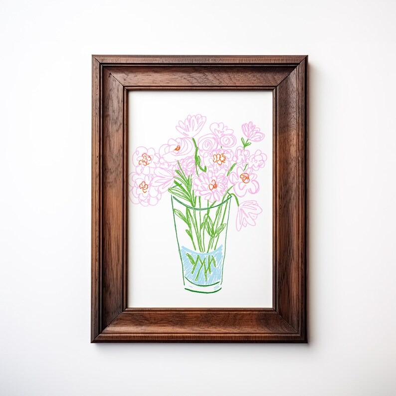 May include: A framed artwork featuring a hand-drawn illustration of pink flowers in a glass vase. The vase has blue water and green stems. The artwork is in a dark brown wooden frame, perfect for home decor.