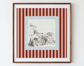 Könnte beinhalten: Ein quadratisches gerahmtes Wandbild mit einem cremefarbenen Quadrat in der Mitte, das eine dunkelbraune Tuschezeichnung eines Dorfes am Hang zeigt. Das zentrale Bild ist von einem hellblauen Rahmen umgeben und liegt auf einem Hintergrund aus vertikalen dunkelbraunen und rosafarbenen Streifen.