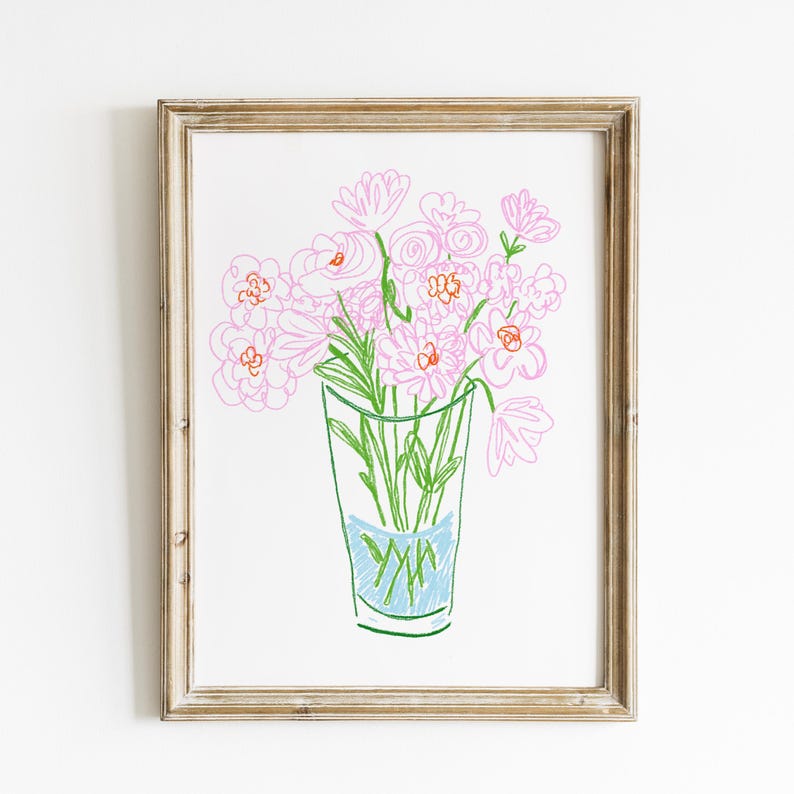 May include: A framed art print featuring a hand-drawn illustration of pink flowers in a clear glass vase. The flowers have pink petals and green stems. The vase has a blue section at the bottom. The frame is a light brown color.