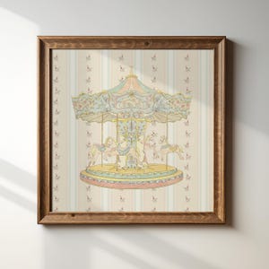 May include: A framed print depicting a carousel in pastel shades. The carousel features horses and a decorative canopy. The background has a striped pattern with small floral accents. The frame is made of wood.