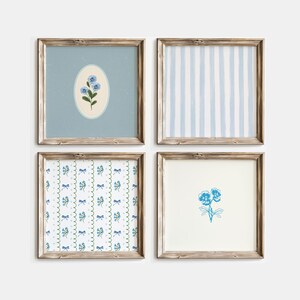 May include: Four framed prints with blue and white floral patterns. The prints are in wooden frames with a light brown finish. The prints are arranged in a grid pattern.
