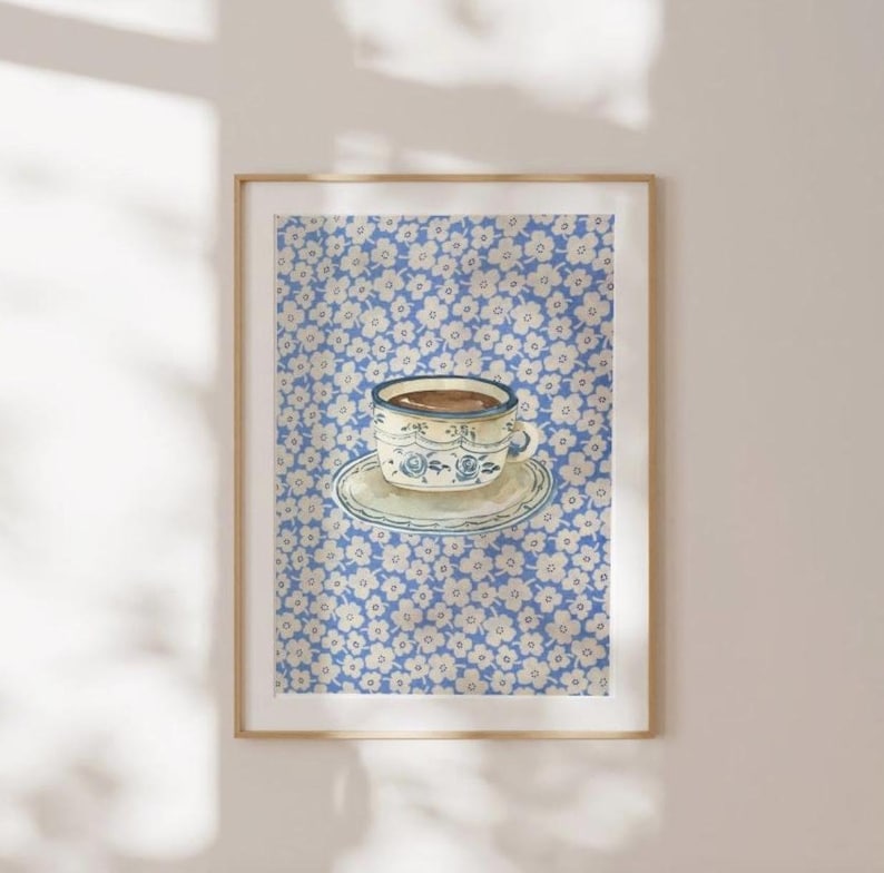 May include: A blue and white teacup with a floral pattern sits on a saucer against a background of white flowers on a blue background.