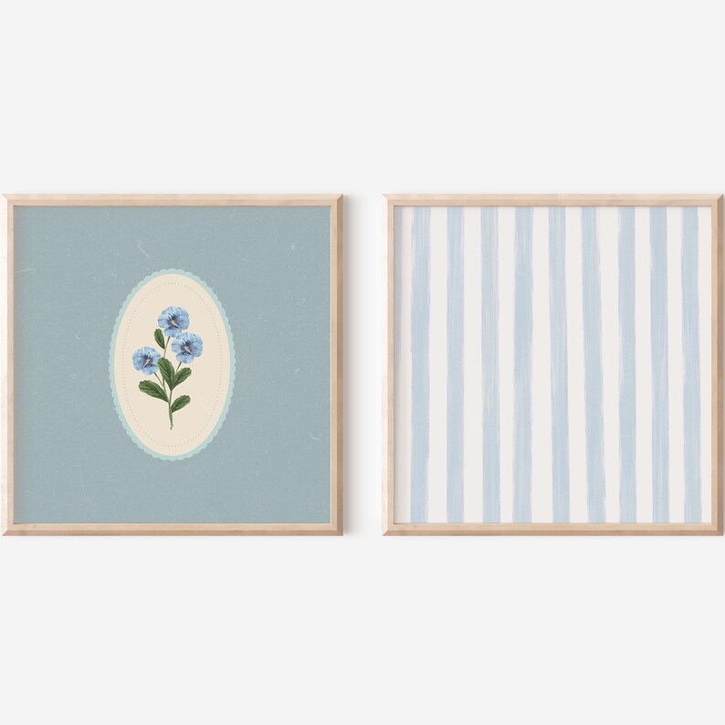 May include: Two framed prints, one with a blue flower illustration in a light blue oval on a light blue background, and the other with a light blue and white striped pattern.