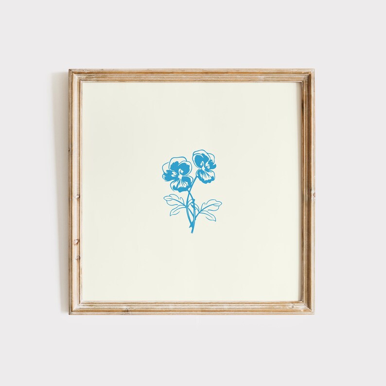 May include: A framed print of a blue floral illustration featuring two pansies with stems and leaves.