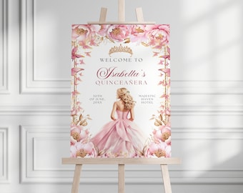 May include: A pink and gold Quinceañera welcome sign with a floral design and a crown. The sign says "Welcome to Isabella's Quinceañera" and includes the date "30th of June, 20XX" and the location "Majestic Haven Hotel".