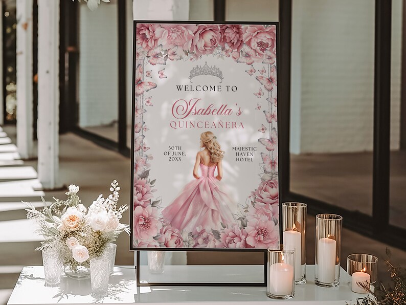 May include: A pink and white welcome sign with floral accents and butterflies. The sign reads "Welcome to Isabella's Quincea&ntilde;era" with the date "30th of June, 20XX" and the location "Majestic Haven Hotel".