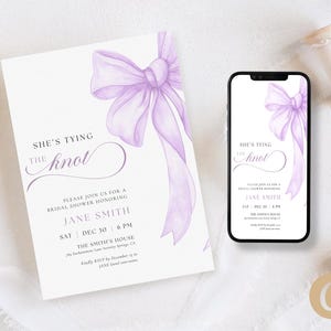May include: A bridal shower invitation and a smartphone displaying the same design. The invitation and phone screen feature a watercolor-style lavender bow and the text "She's Tying the Knot". The invitation includes event details.