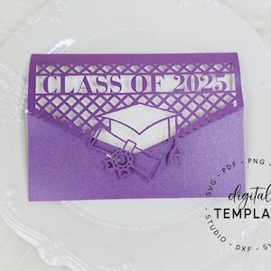May include: Purple graduation card with a cut-out design of a graduation cap and diploma. The card says "Class of 2025" at the top.
