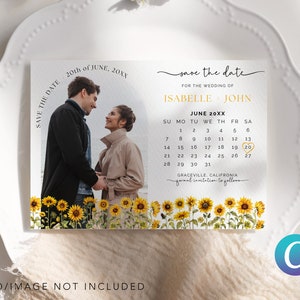 May include: Save the date card with a photo of a couple in front of a field of sunflowers. The card has a calendar with the date June 20th circled. The text on the card reads "Save the date for the wedding of Isabelle & John, June 20XX, Graceville, California, formal invitation to follow."