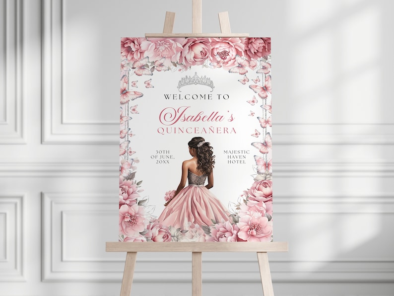 May include: A welcome sign for a Quincea&ntilde;era with a pink floral border and butterflies. The sign says "Welcome to Isabella's Quincea&ntilde;era" with the date and location. A young woman in a pink dress is in the center of the sign.