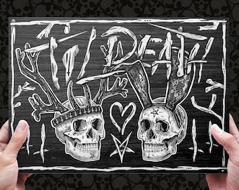 May include: Black and white illustration of two skulls with antlers and bunny ears. The skulls are wearing crowns and have a heart between them. The background is a black wooden surface with the word "DEATH" written in white.