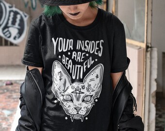 May include: A black t-shirt with a graphic of a cat's head and the text "Your insides are beautiful".
