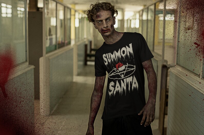 May include: A black t-shirt with the text "SUMMON SANTA" in a distressed, gothic font, featuring a pentagram and Santa hat design. The image has a horror theme, with a zombie-like figure in a hallway.