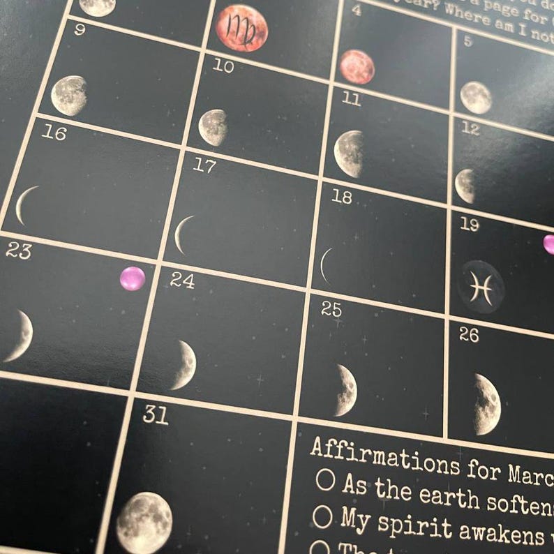 May include: A black calendar with a grid layout, featuring moon phase illustrations and astrological symbols. The calendar includes dates and affirmations for March. The background has a starry night design.