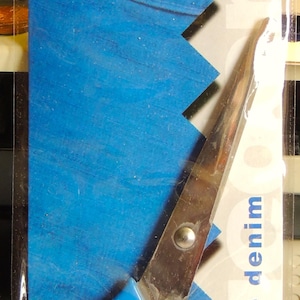 May include: Blue heavy-duty scissors with a silver blade, packaged on a blue and white card with the text "Dexfield Multi-Use Heavy Gauge blue denim L552 7" 18cm".