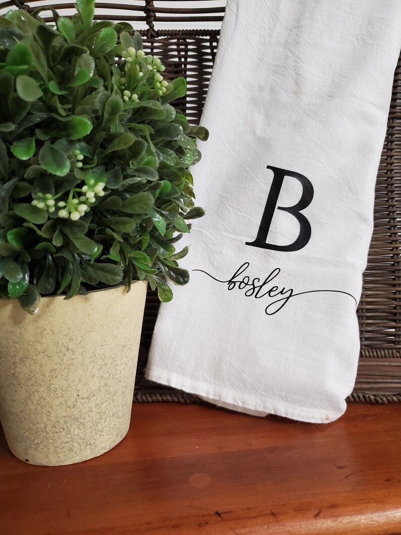 May include: White kitchen towel with a black letter B and the name "Bosley" written in cursive.