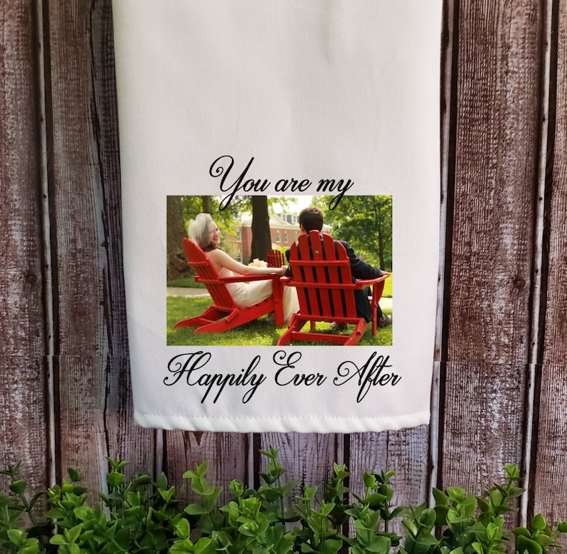 May include: A white tea towel with a photo of a couple sitting on red chairs in a grassy area. The text "You are my Happily Ever After" is printed on the towel.