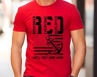 May include: A red t-shirt with a black graphic design. The design includes the word "RED" in large block letters, the American flag, an anchor, and the text "REMEMBER EVERYONE DEPLOYED UNTIL THEY COME HOME."