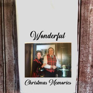 May include: A white kitchen towel with a black and white photo of an older couple in a kitchen. The text "Wonderful Christmas Memories" is printed below the photo.