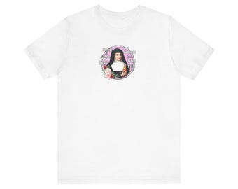 May include: White t-shirt featuring a graphic of a nun with text that reads "Keep a light heart, put sadness far from you." The graphic is surrounded by a pink circle and floral accents. The shirt is made of a soft material.