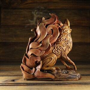 May include: A wooden sculpture of a fox with intricate details and a swirling, flame-like tail. The sculpture is carved from a single piece of wood and has a natural, rustic finish.