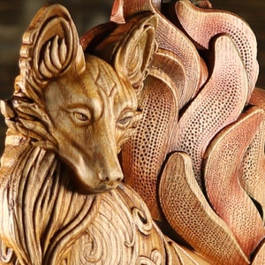 May include: A detailed wooden carving of a fox with intricate details in the fur and a flowing tail. The carving is painted in shades of brown and gold.