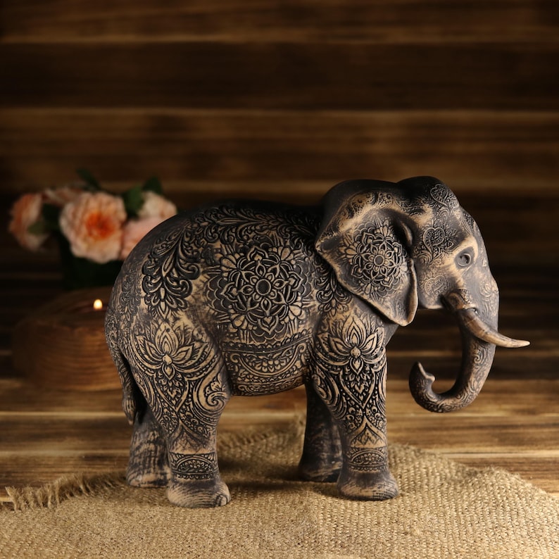 Sacred luck wood art of an elephant standing on an old wooden surface, atmospheric studio lighting shot.