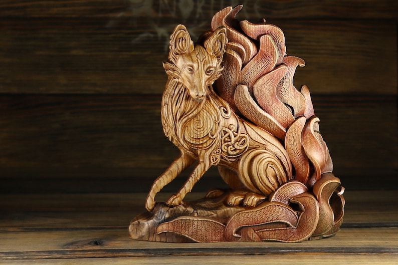 May include: A wooden sculpture of a fox with intricate carvings and a flowing tail. The fox is sitting on a base with carved leaves and flowers.