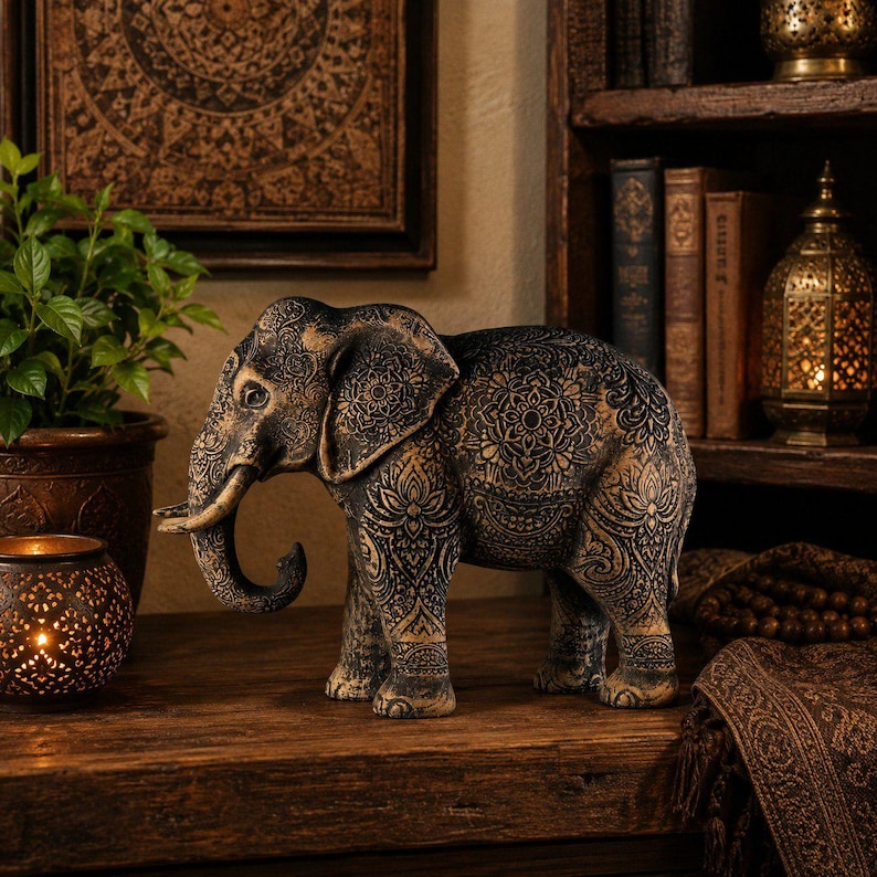 Bohemian style wood carving of a standing black elephant with detailed mandalas and an antique metallic patina finish.