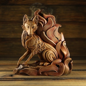 May include: A wooden sculpture of a fox with a large, elaborate tail made of swirling, intricate patterns. The fox is carved in a realistic style with detailed features and a lifelike pose.