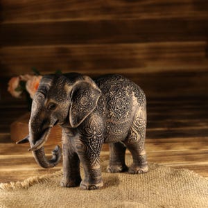 Handcrafted oriental guardian totem featuring a textured hairy elephant, scorched wood accent finishing.