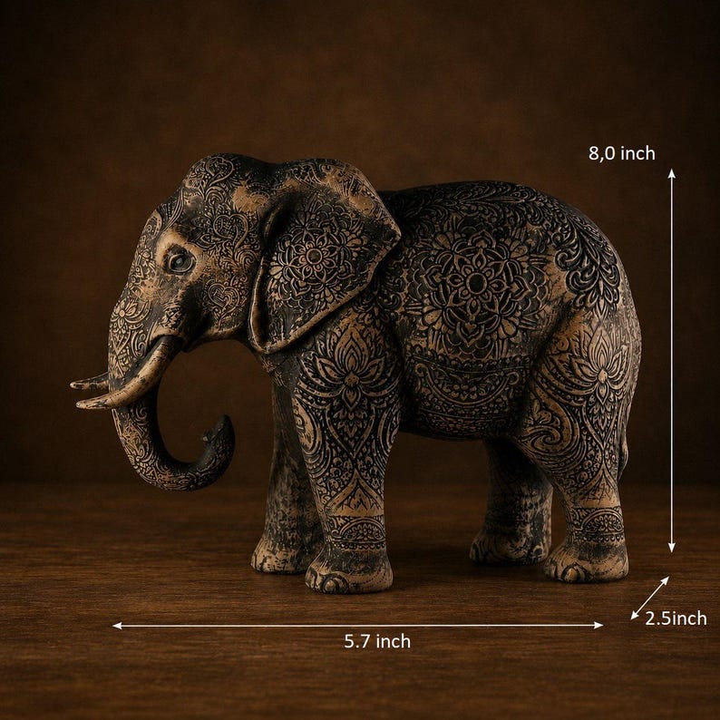 Bohemian style wood carving of a standing black elephant with detailed mandalas and an antique metallic patina finish.