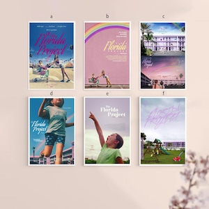 Puede incluir: Se muestran seis carteles enmarcados de la película "The Florida Project". Los carteles utilizan colores brillantes, incluyendo rosa, azul y verde. Los carteles muestran escenas de la película, incluyendo un arco iris, palmeras y niños.