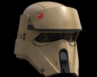 Könnte beinhalten: Beigefarbener Helm mit Visier und rotem Emblem an der Seite. Der Helm hat ein dunkles Visier und einen vorderen Bereich mit Lautsprecher- und Lüftungsdetails. Wahrscheinlich ein Requisit oder Kostüm.