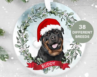 Natale biglietto di auguri. Rottweiler cane con red Santa's hat e campane di Natale Immagine e Vettoriale