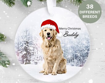 May include: Round Christmas ornament featuring a Golden Retriever wearing a Santa hat. The ornament has a winter forest scene background and the text "Merry Christmas Buddy". A green circle indicates "38 DIFFERENT BREEDS".