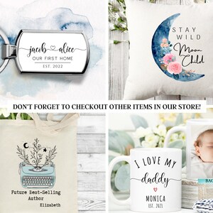 May include: A set of four personalized gifts featuring a variety of designs. The first is a silver key chain with a rectangular tag that reads "jacob alice OUR FIRST HOME EST. 2022". The second is a white pillow with a blue and pink watercolor moon with flowers and the text "STAY WILD Moon Child". The third is a white tote bag with a vintage typewriter illustration and the text "Future Best-Selling Author Elizabeth". The fourth is a white mug with the text "I LOVE MY daddy ♡ MONICA EST. 2021" and a photo of a baby on the back.