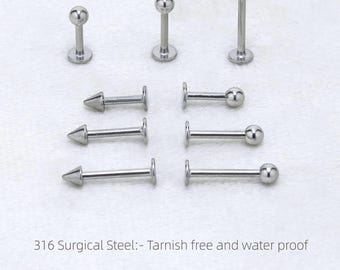 May include: A selection of silver body jewellery, including barbell and stud designs. The studs feature either a ball or cone shape. The image text states "316 Surgical Steel: - Tarnish free and water proof" and lists sizes in millimeters.