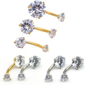 May include: Three pairs of belly button rings with clear crystal stones. The rings are available in gold and silver.
