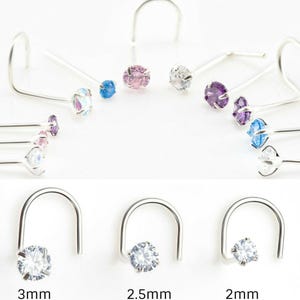 May include: A set of three nose rings with clear cubic zirconia stones. The rings are available in three sizes: 2mm, 2.5mm, and 3mm.