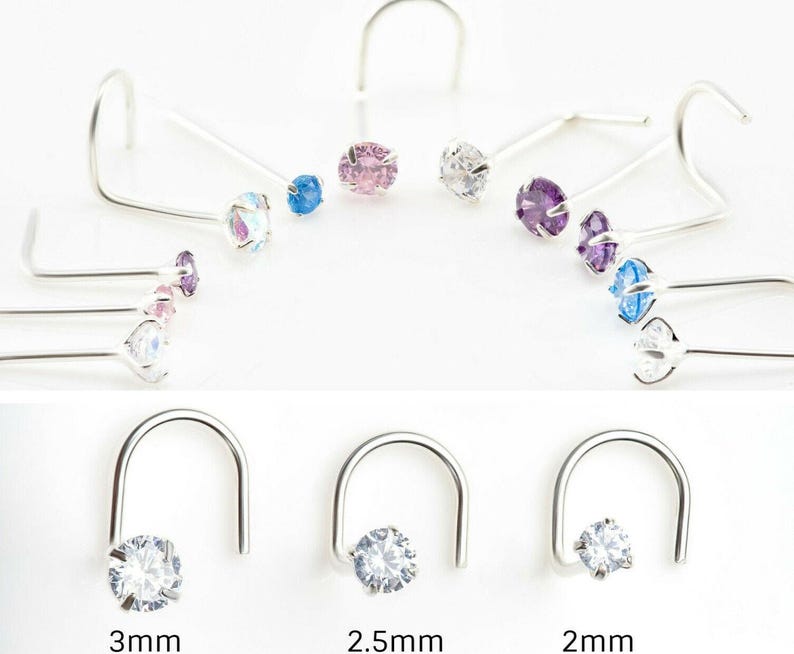 May include: A set of three nose rings with clear cubic zirconia stones. The rings are available in three sizes: 2mm, 2.5mm, and 3mm.