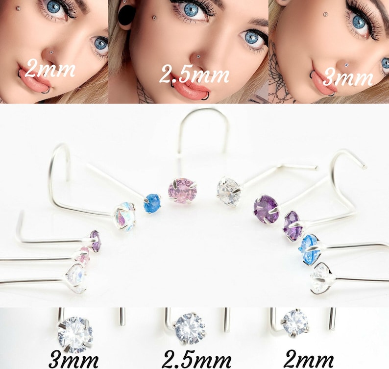 May include: A set of nose rings with different colored gemstones. The rings are available in 2mm, 2.5mm, and 3mm sizes. The gemstones are clear, pink, blue, and purple.