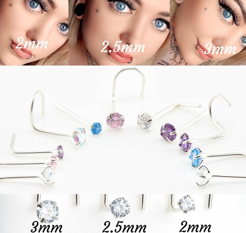 May include: A set of nose rings with different colored gemstones. The rings are available in 2mm, 2.5mm, and 3mm sizes. The gemstones are clear, pink, blue, and purple.